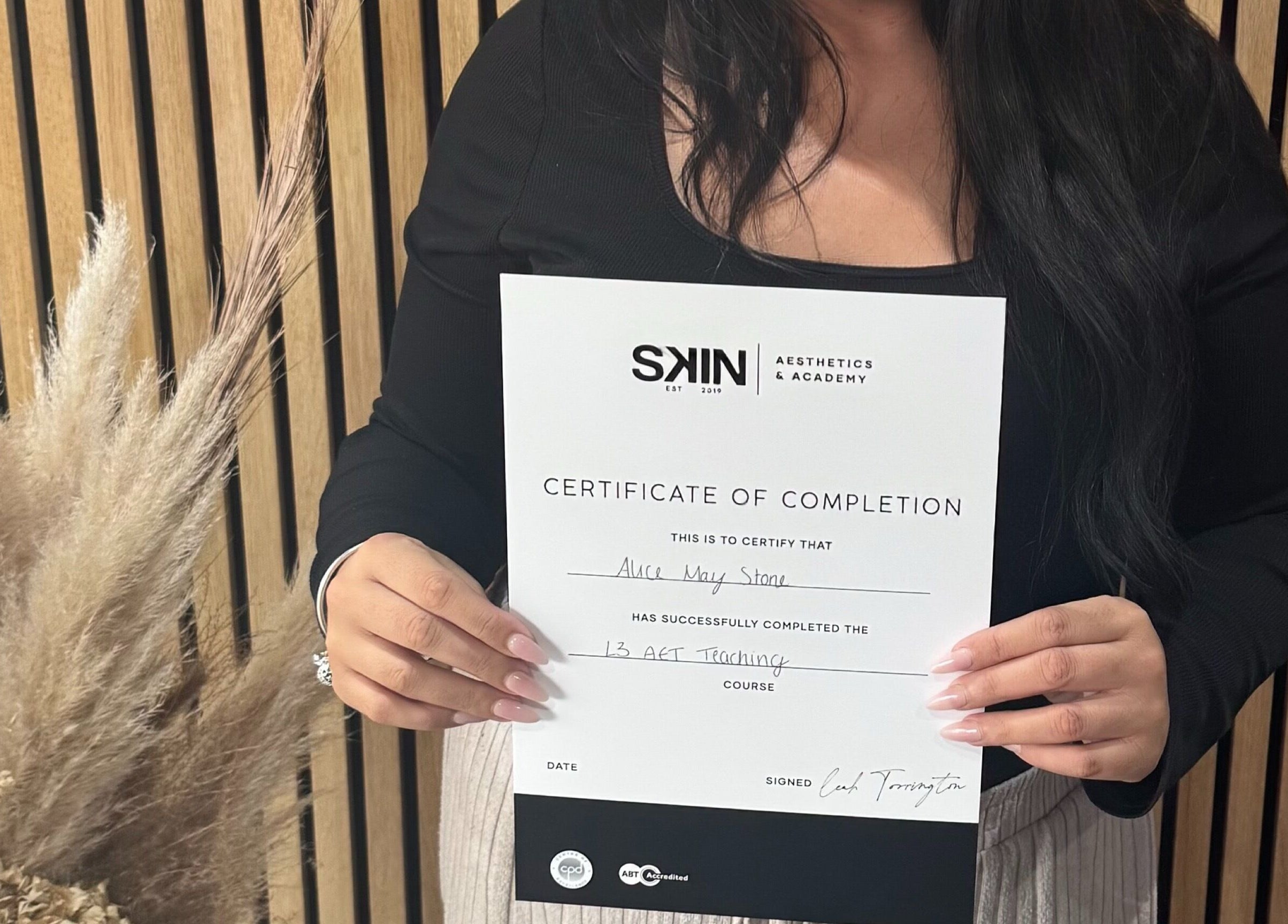 Person holding completion certificate for Alice May Lashes course in Crawley, England, GB.