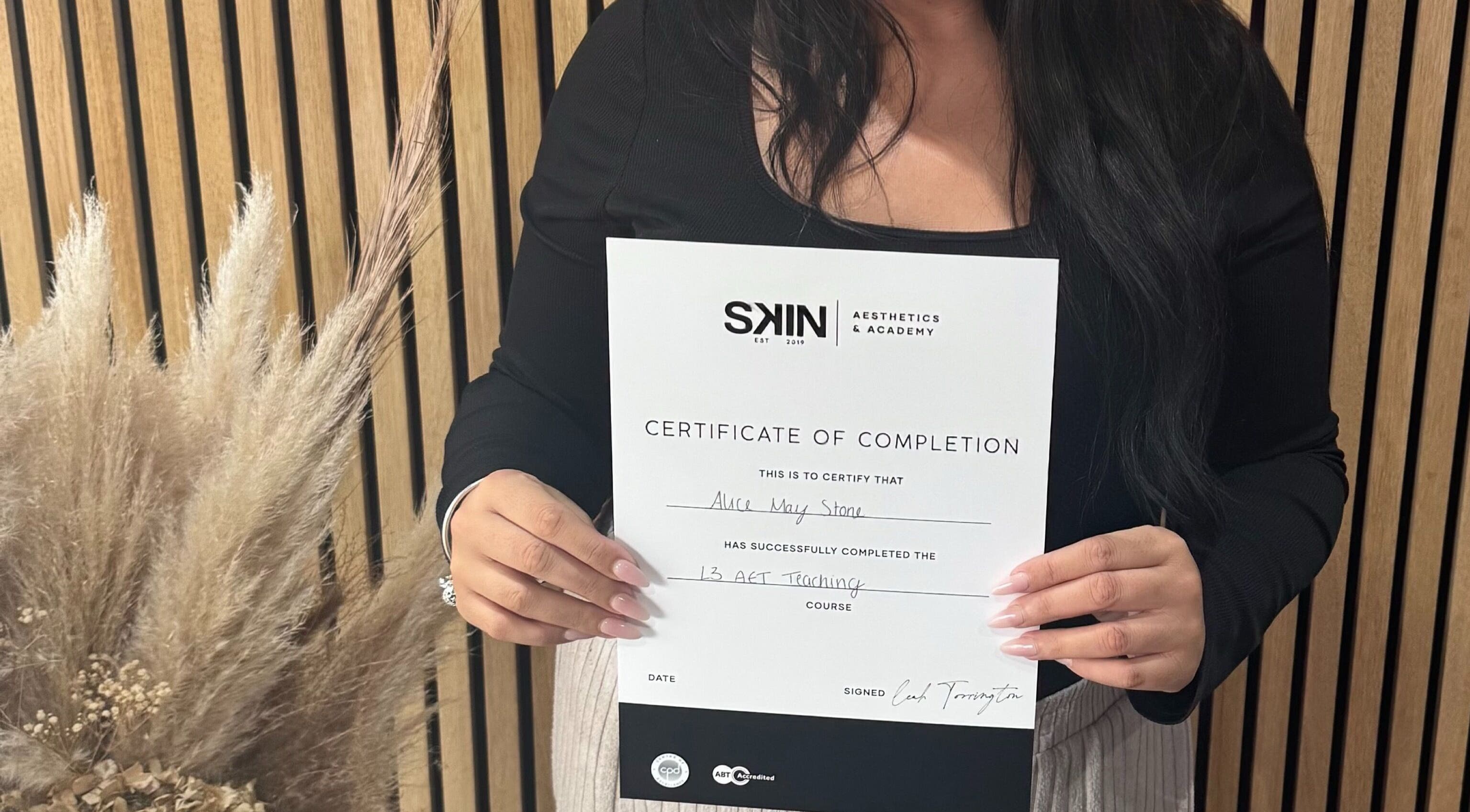 Person holding completion certificate for Alice May Lashes course in Crawley, England, GB.