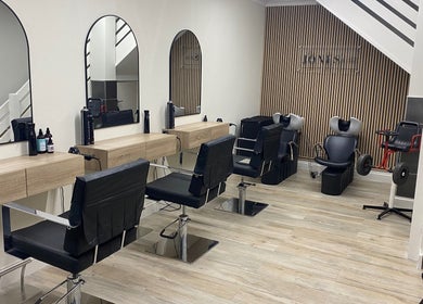Modern salon interior at Jones & Co, Saint Ives, England, GB, featuring stylish chairs and mirrors.