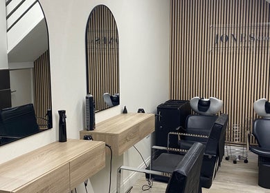 Elegant salon interior at Jones & Co, Saint Ives, England with sleek mirrors and stylish chairs.