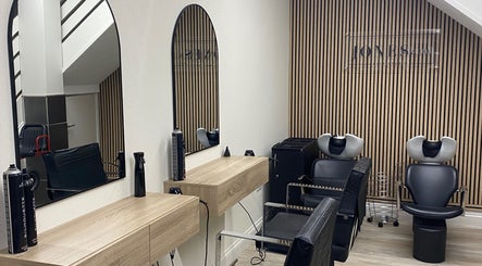 Elegant salon interior at Jones & Co, Saint Ives, England with sleek mirrors and stylish chairs.