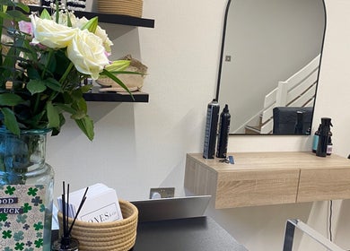 Modern styling station at Jones & Co, Saint Ives, England, GB with mirrors and fresh flowers.