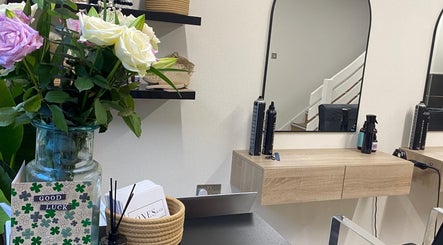 Modern styling station at Jones & Co, Saint Ives, England, GB with mirrors and fresh flowers.