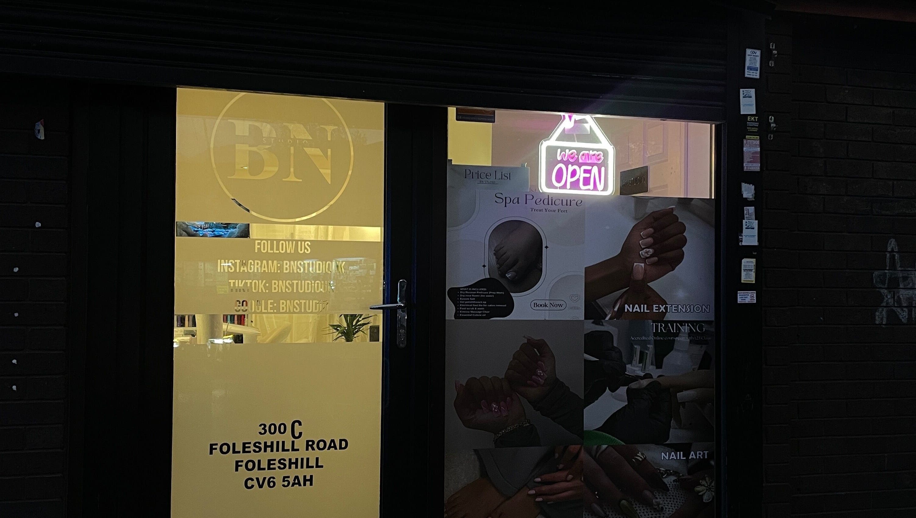 Front entrance of BN STUDIO with glowing neon sign, Coventry, England, GB.