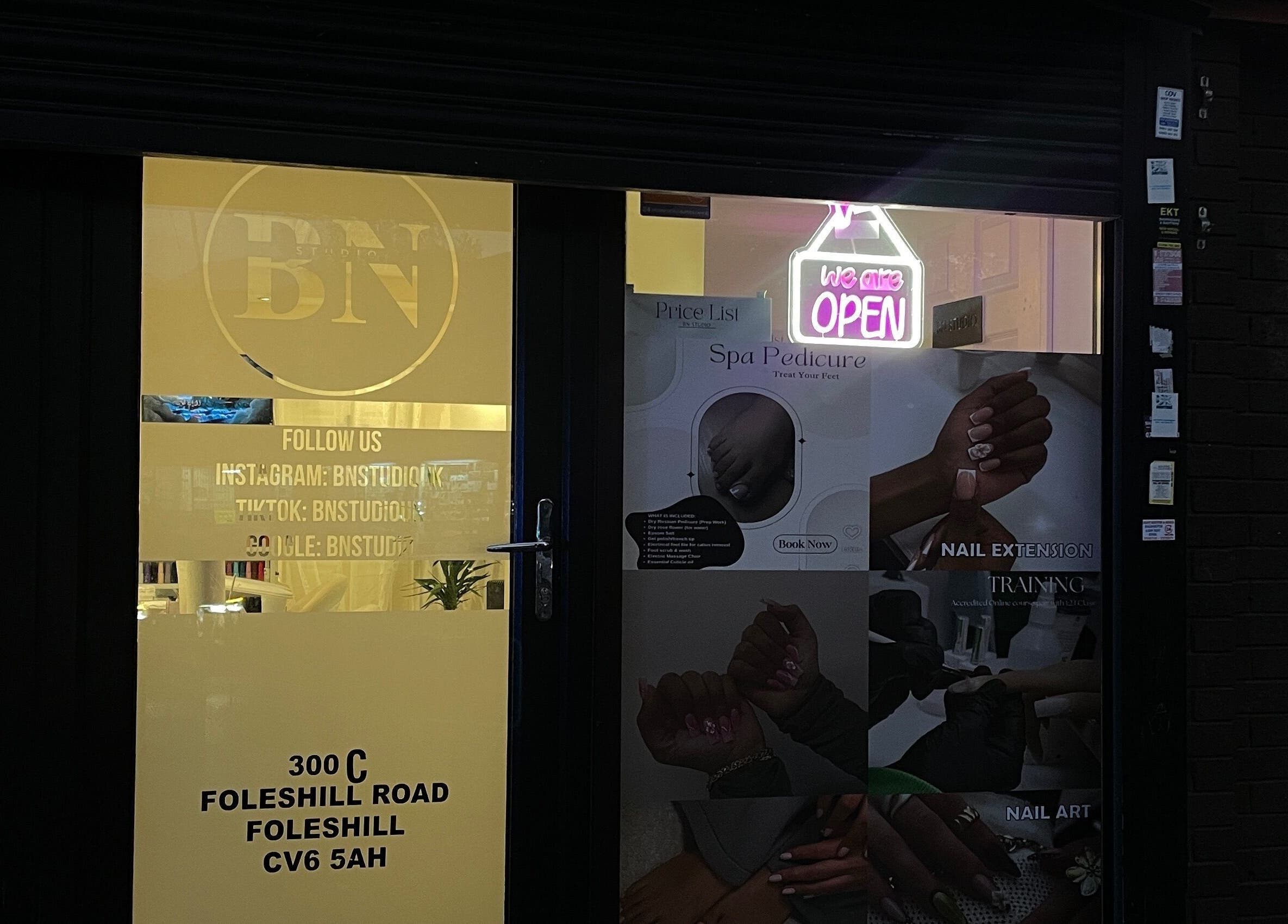 Bn Studio entrance with illuminated open sign at 300C Foleshill Road, Coventry, England, GB.