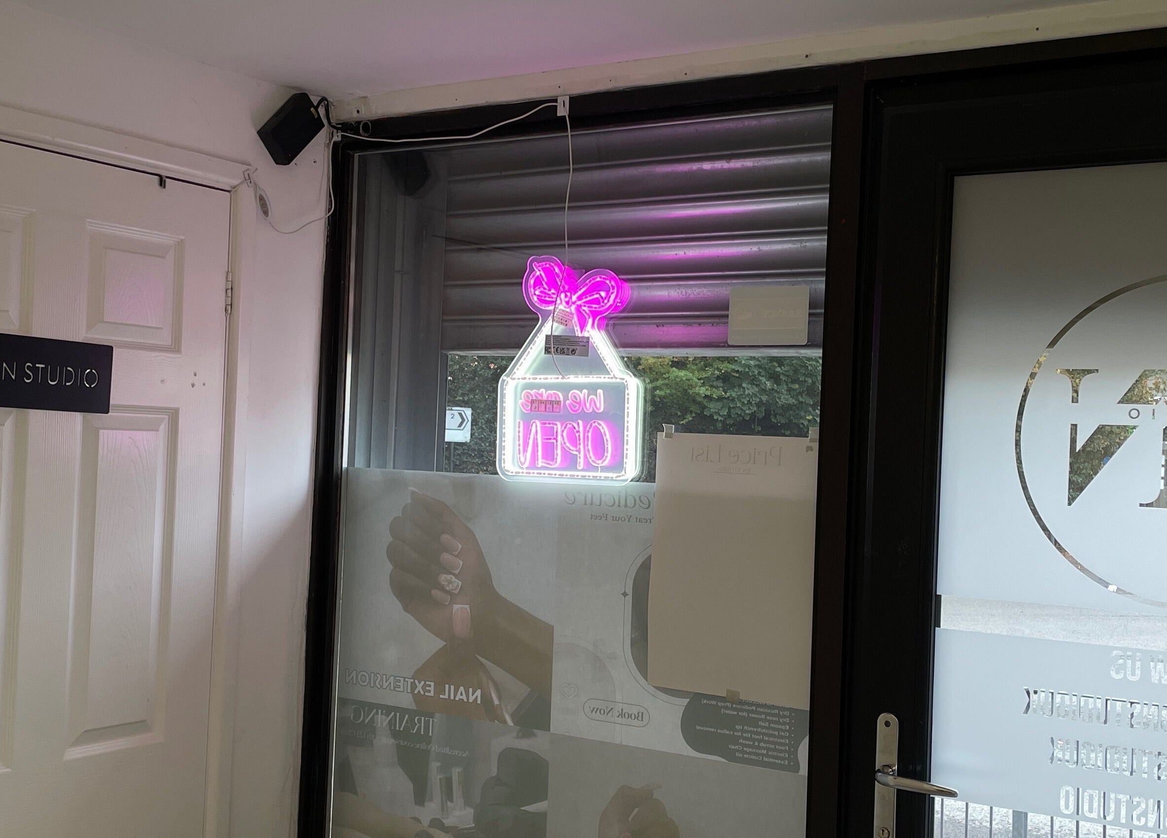 Entrance of Bn Studio, Coventry, England, GB with neon open sign and branded door.