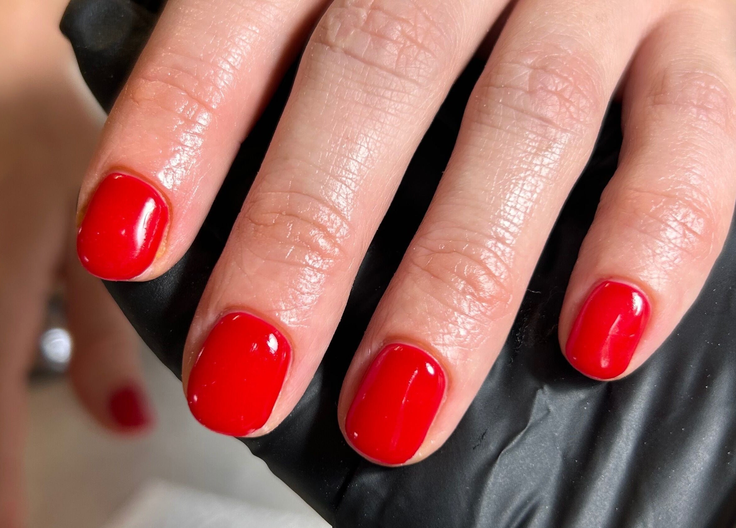 Vibrant red manicured nails at Shefford Manicurist in Shefford, England, GB.