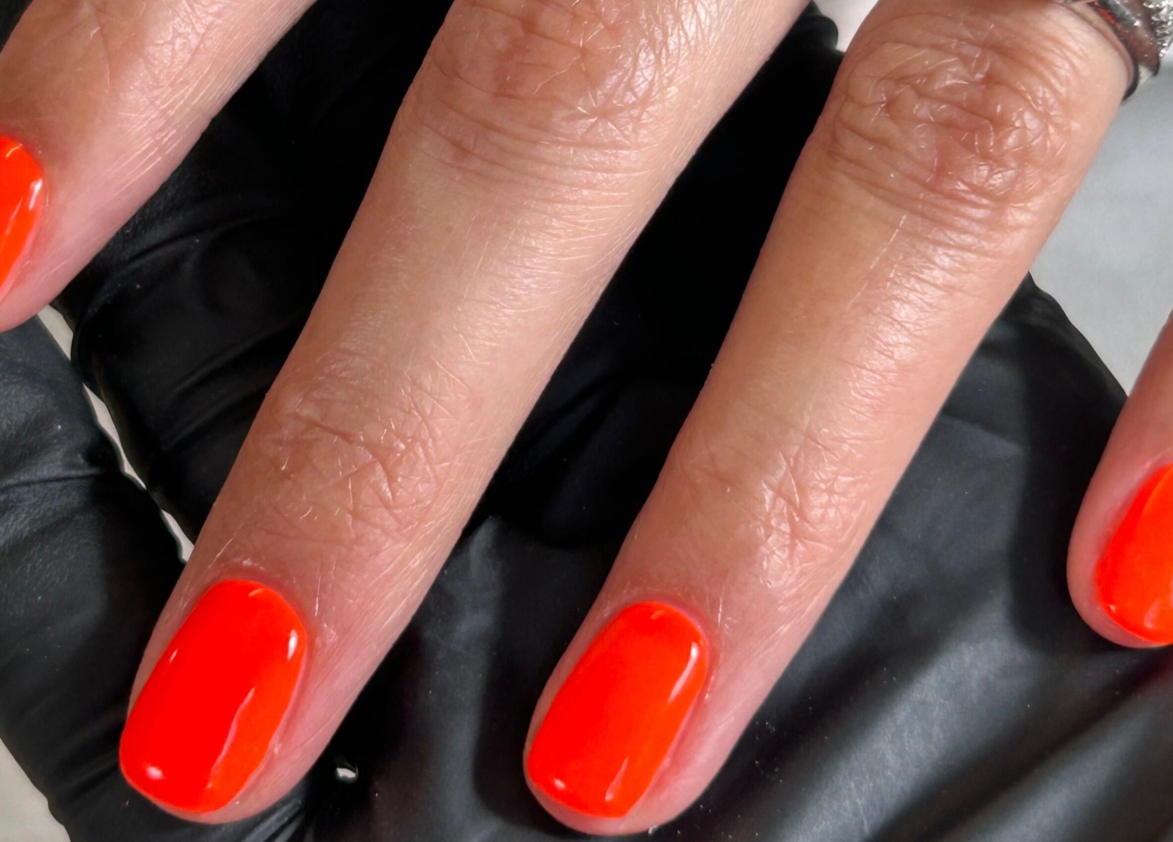 Bright orange manicure at Shefford Manicurist, Shefford, England, GB showcasing vibrant nail art.