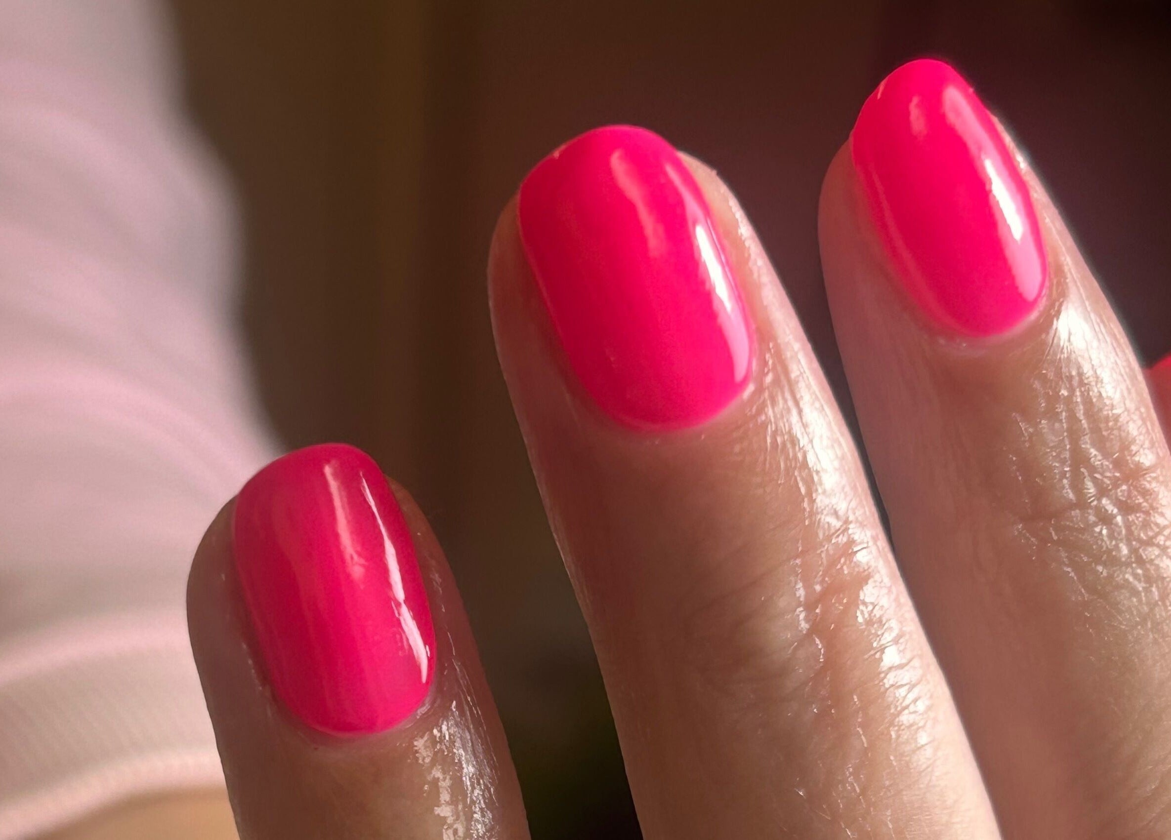 Bright pink manicure from Shefford Manicurist in Shefford, England, GB showcasing glossy nails.