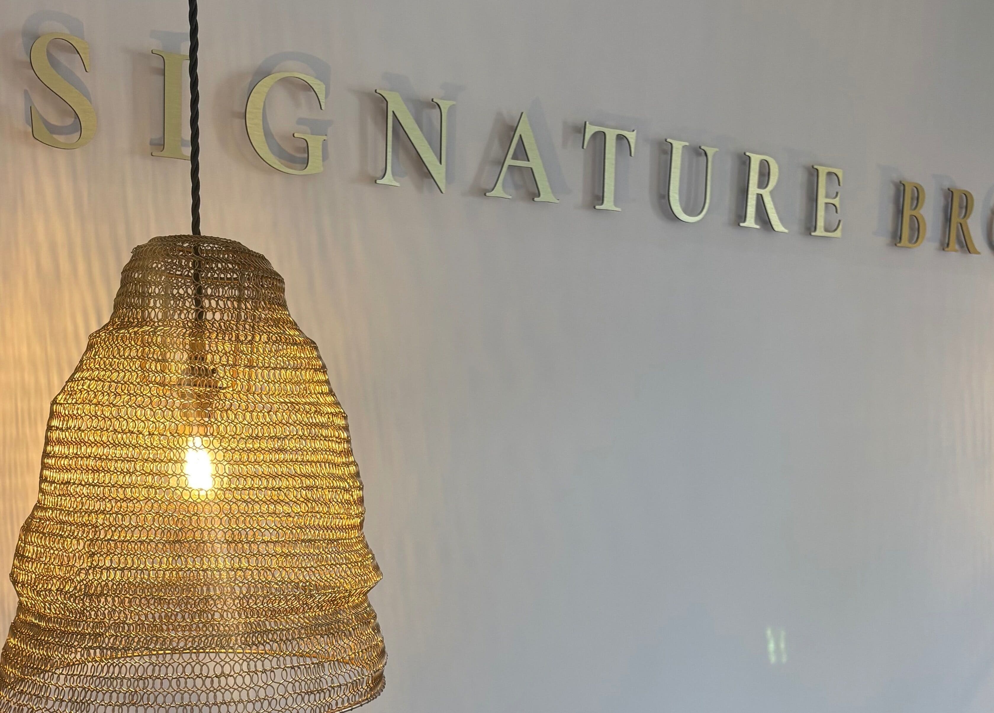 Warm lighting and decor at Signature Brows in Bridgend, Wales, GB, creating an inviting ambiance.