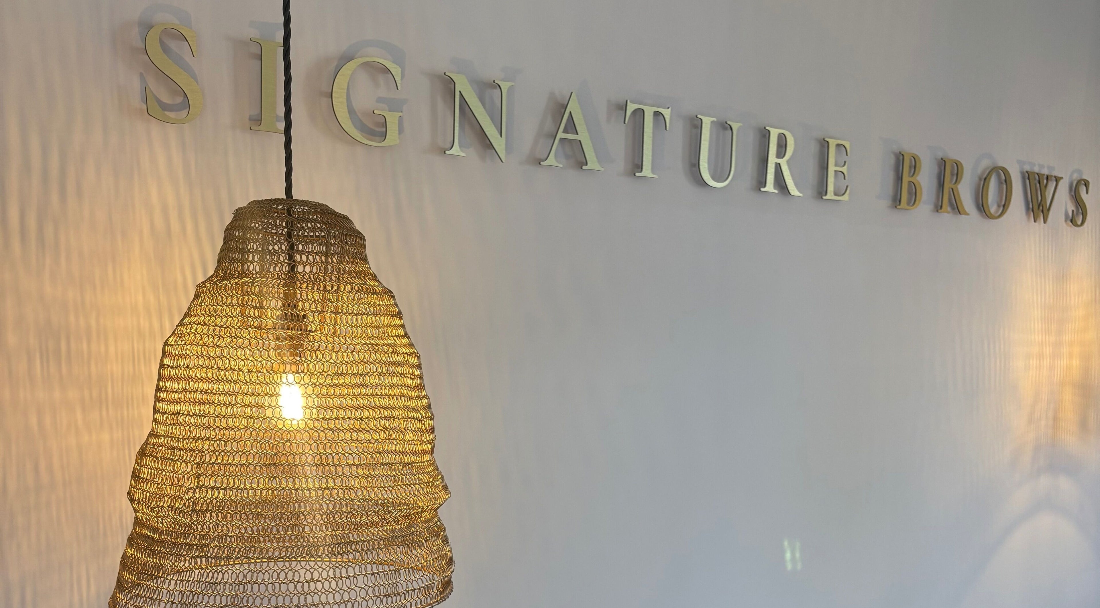 Warm lighting and decor at Signature Brows in Bridgend, Wales, GB, creating an inviting ambiance.