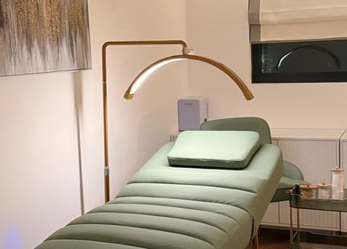 Calm treatment room at Essential Beauty Essex - Rayleigh, Rayleigh, England, GB with a plush green bed.