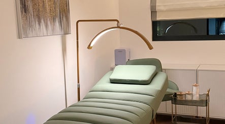 Calm treatment room at Essential Beauty Essex - Rayleigh, Rayleigh, England, GB with a plush green bed.
