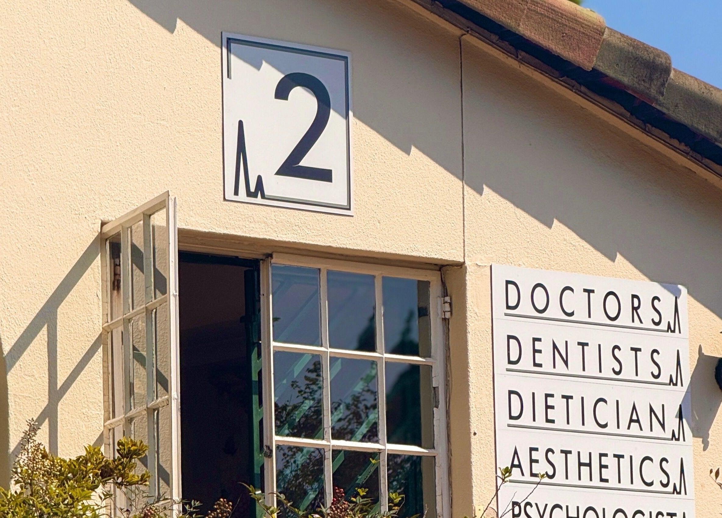 Mii Health venue facade in Johannesburg, Gauteng, ZA, featuring vibrant signage for various wellness services.