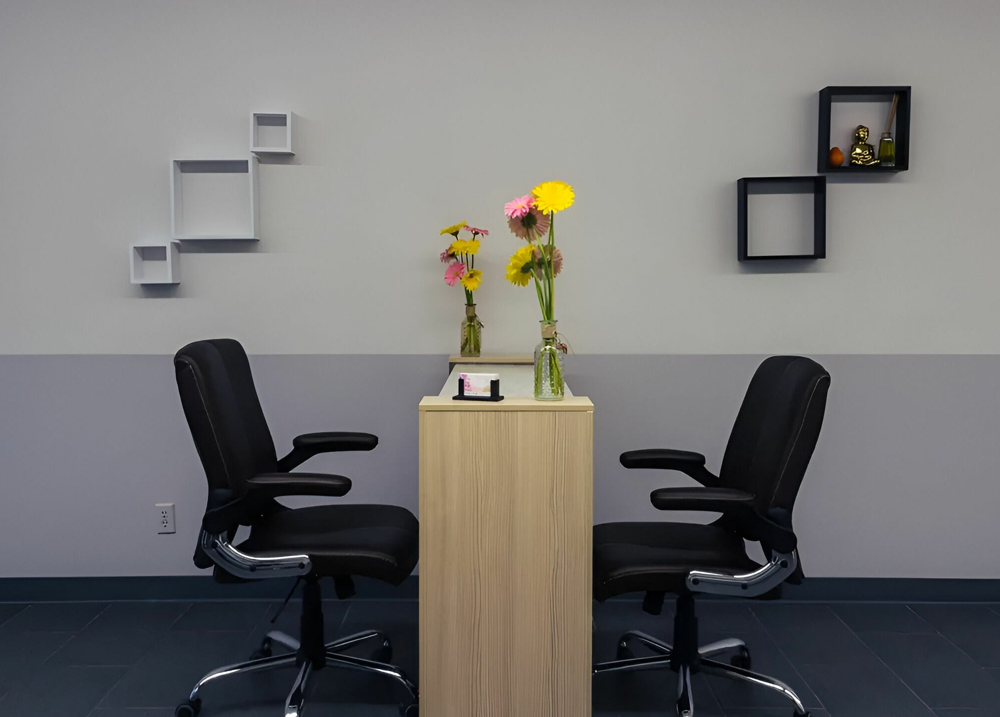 Chic nail station at Gentle Nails, St. Louis, Missouri, US, featuring sleek chairs and vibrant flowers.