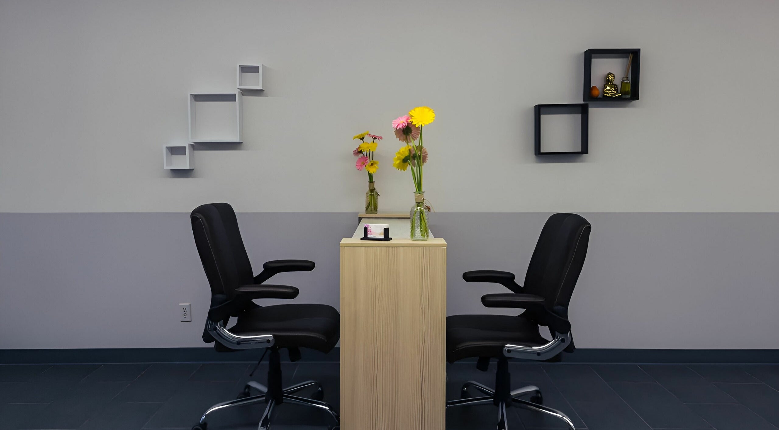 Chic nail station at Gentle Nails, St. Louis, Missouri, US, featuring sleek chairs and vibrant flowers.