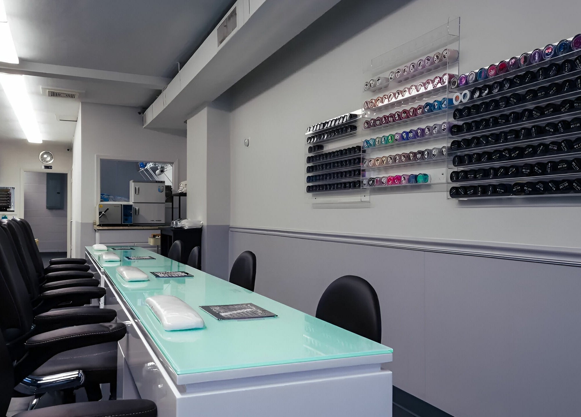 Bright nail salon interior at Gentle Nails, St. Louis, Missouri, US featuring modern manicure stations.