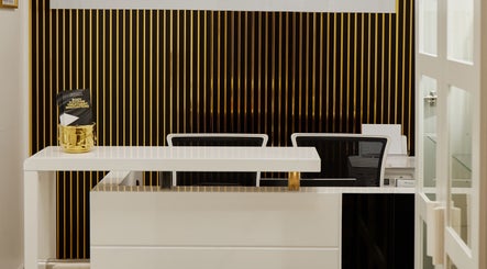 Elegant front desk at Skin Masters Aesthetics Center, Lusail, Al Daayen Municipality, QA. Modern decor with gold accents.