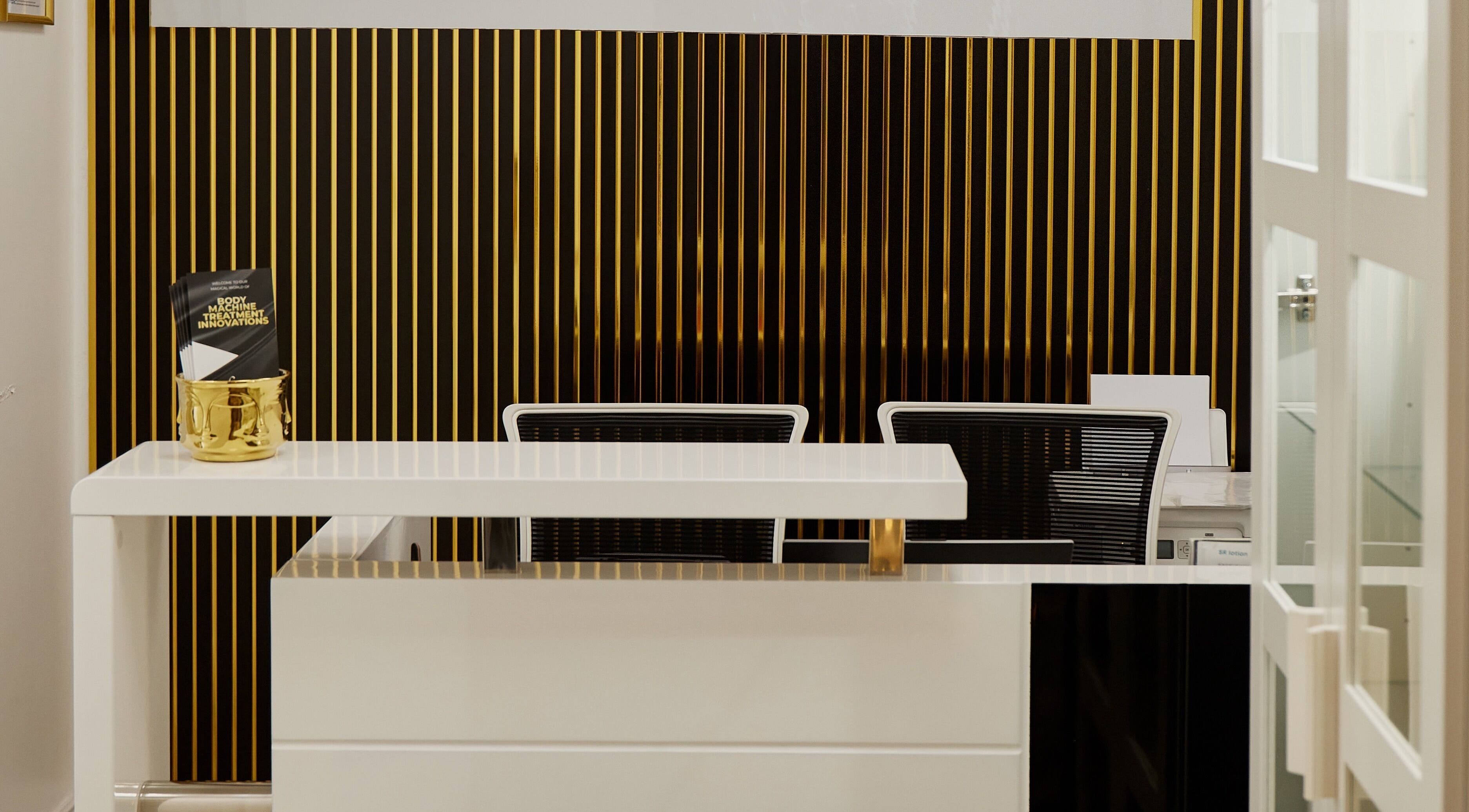 Sleek reception area at Skin Masters Aesthetics Center in Lusail, Al Daayen Municipality, QA with gold accents.