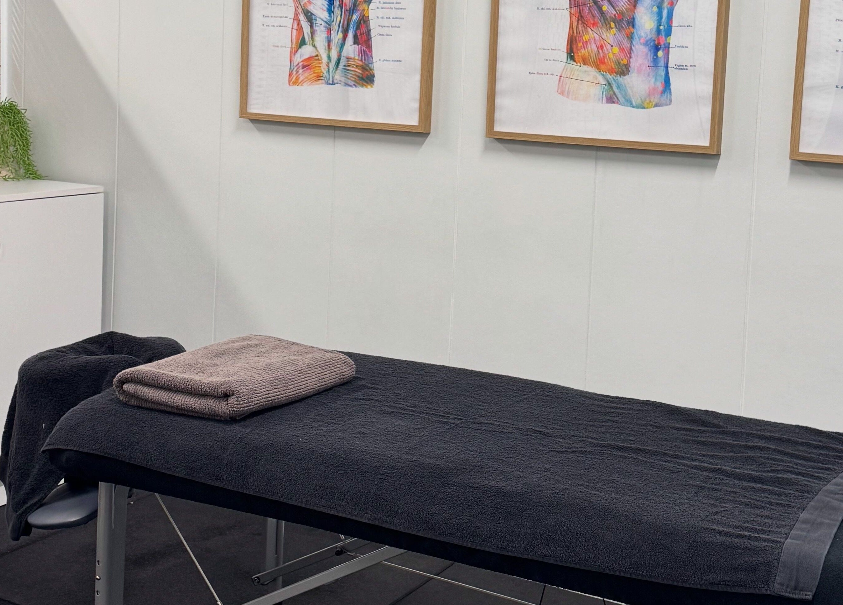 Relaxing massage room at Proform Coaching and Massage, Singleton, New South Wales, AU with art on the walls.