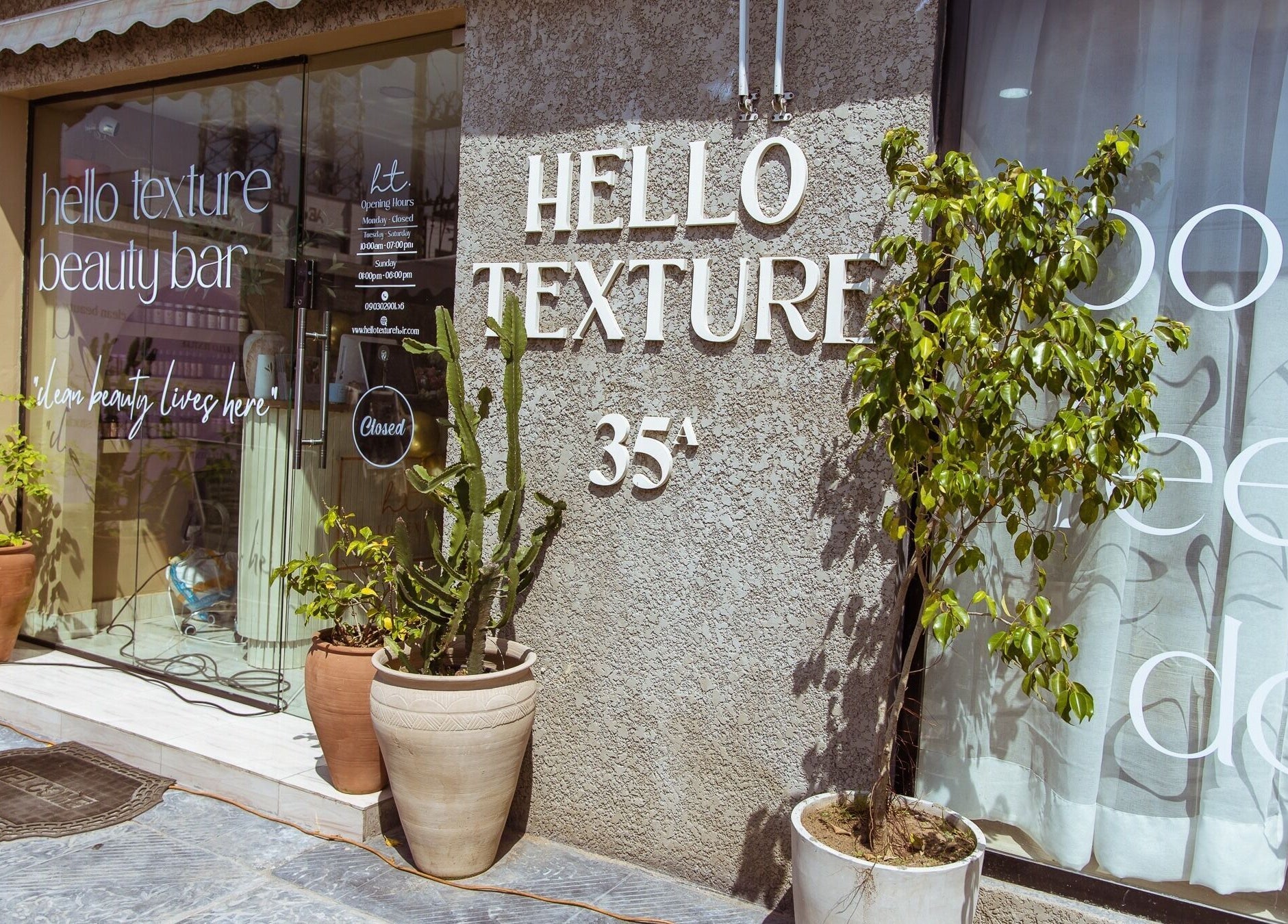 Front view of Hello Texture beauty bar in Lekki, Lagos, NG, showcasing potted plants and modern decor.