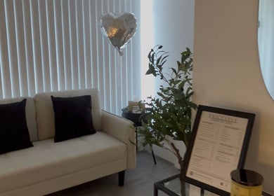 Inviting lounge at Lashed by Jade, Heysham, England, GB, featuring a white sofa and decor in a serene setting.