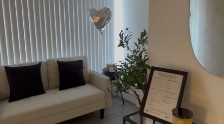 Inviting lounge at Lashed by Jade, Heysham, England, GB, featuring a white sofa and decor in a serene setting.