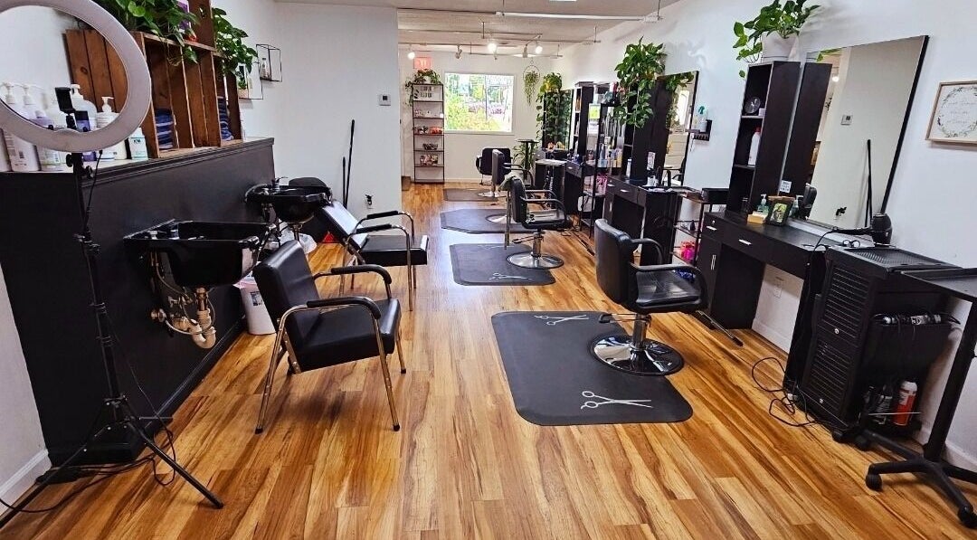 Chic interior of Rose Room Salon in Oxford, Ohio, US featuring modern styling chairs and wash stations.