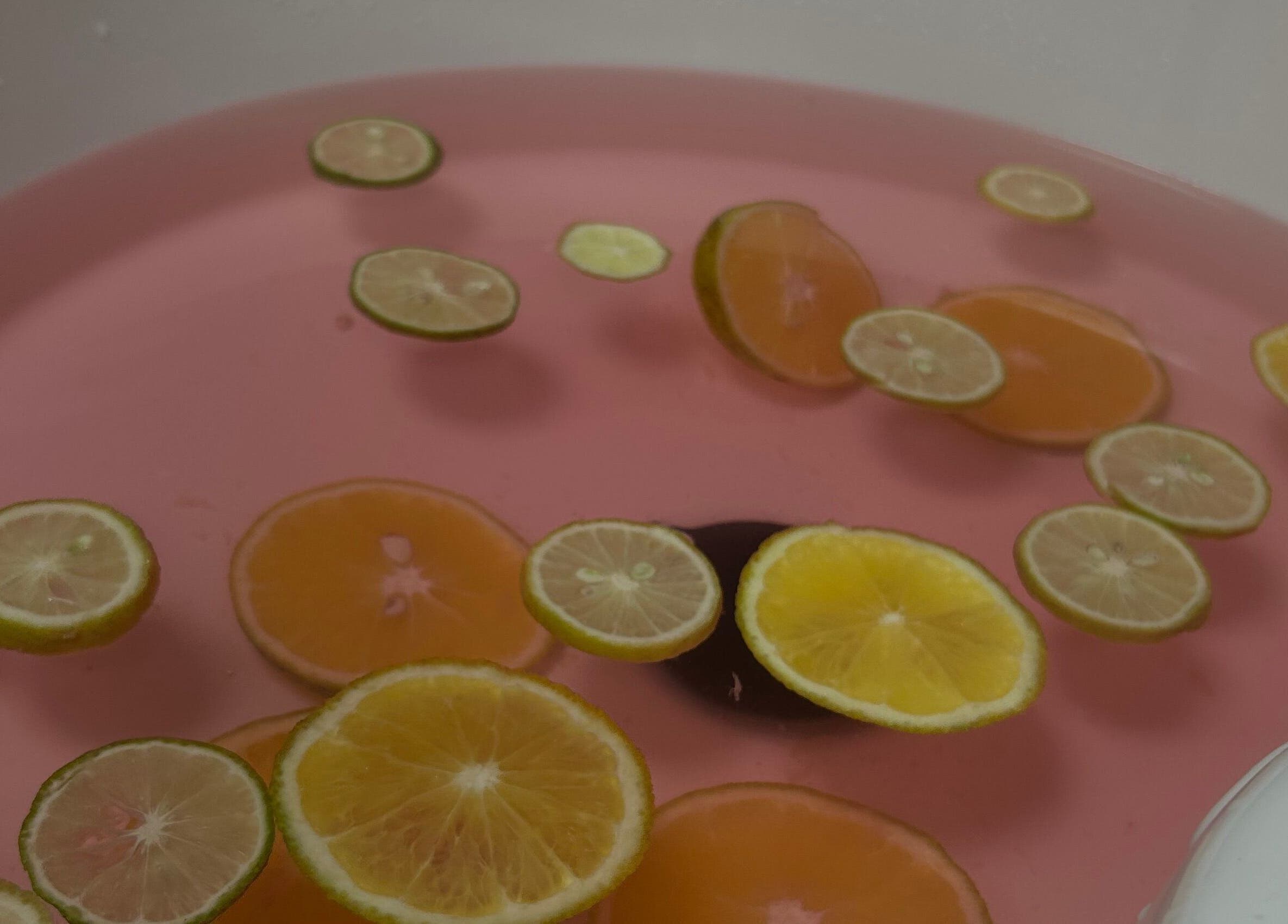 Invigorating citrus slices float in a pink spa bath at Fayva Day Spa, Chaguanas, Chaguanas, TT, enhancing relaxation.