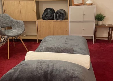 Cozy therapy room at Leamington Therapy in Royal Leamington Spa, England, GB with gray chair and cabinets.