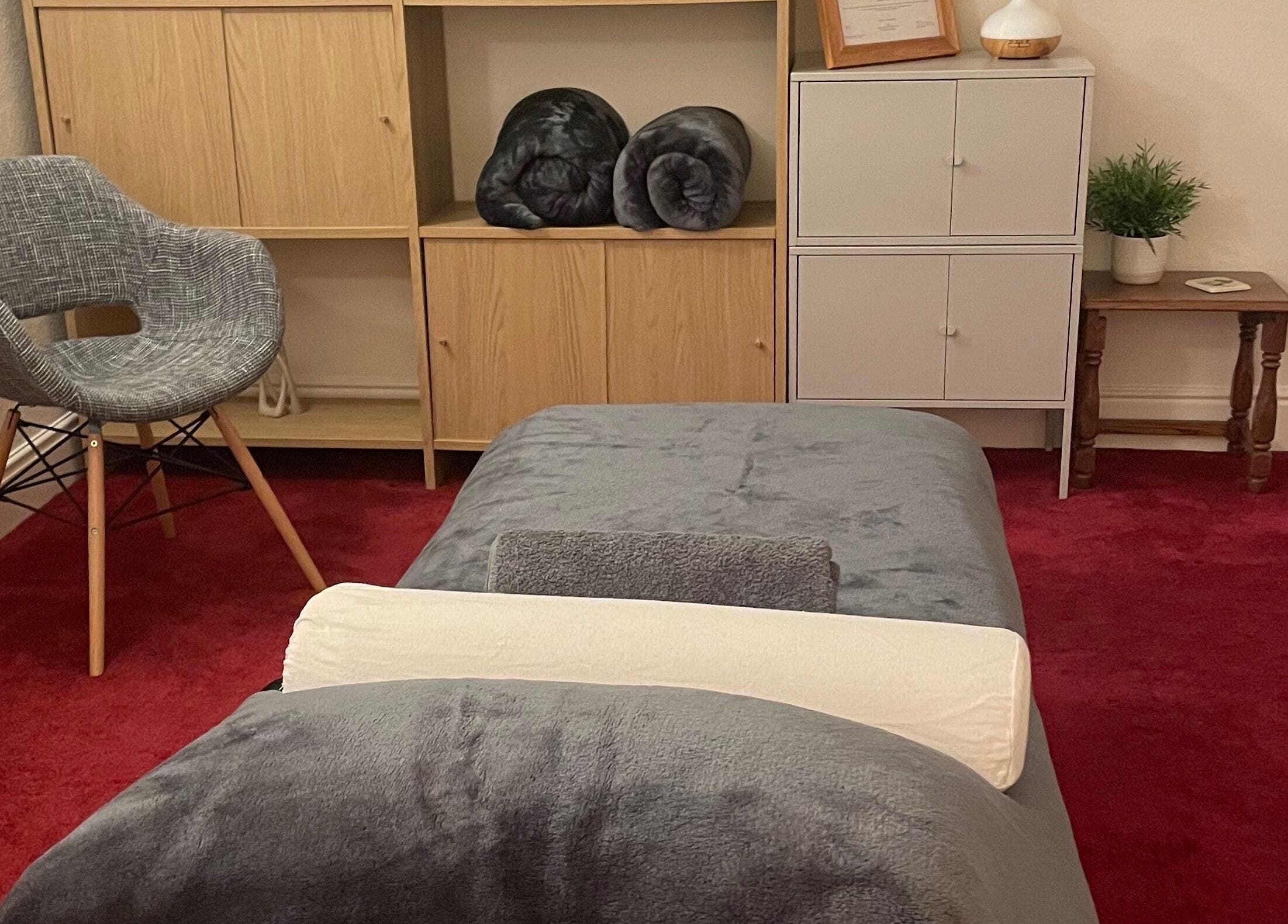 Cozy therapy room at Leamington Therapy in Royal Leamington Spa, England, GB with gray chair and cabinets.