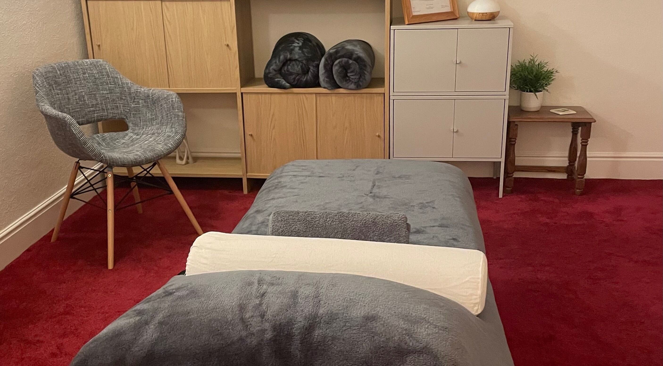 Cozy therapy room at Leamington Therapy in Royal Leamington Spa, England, GB with gray chair and cabinets.