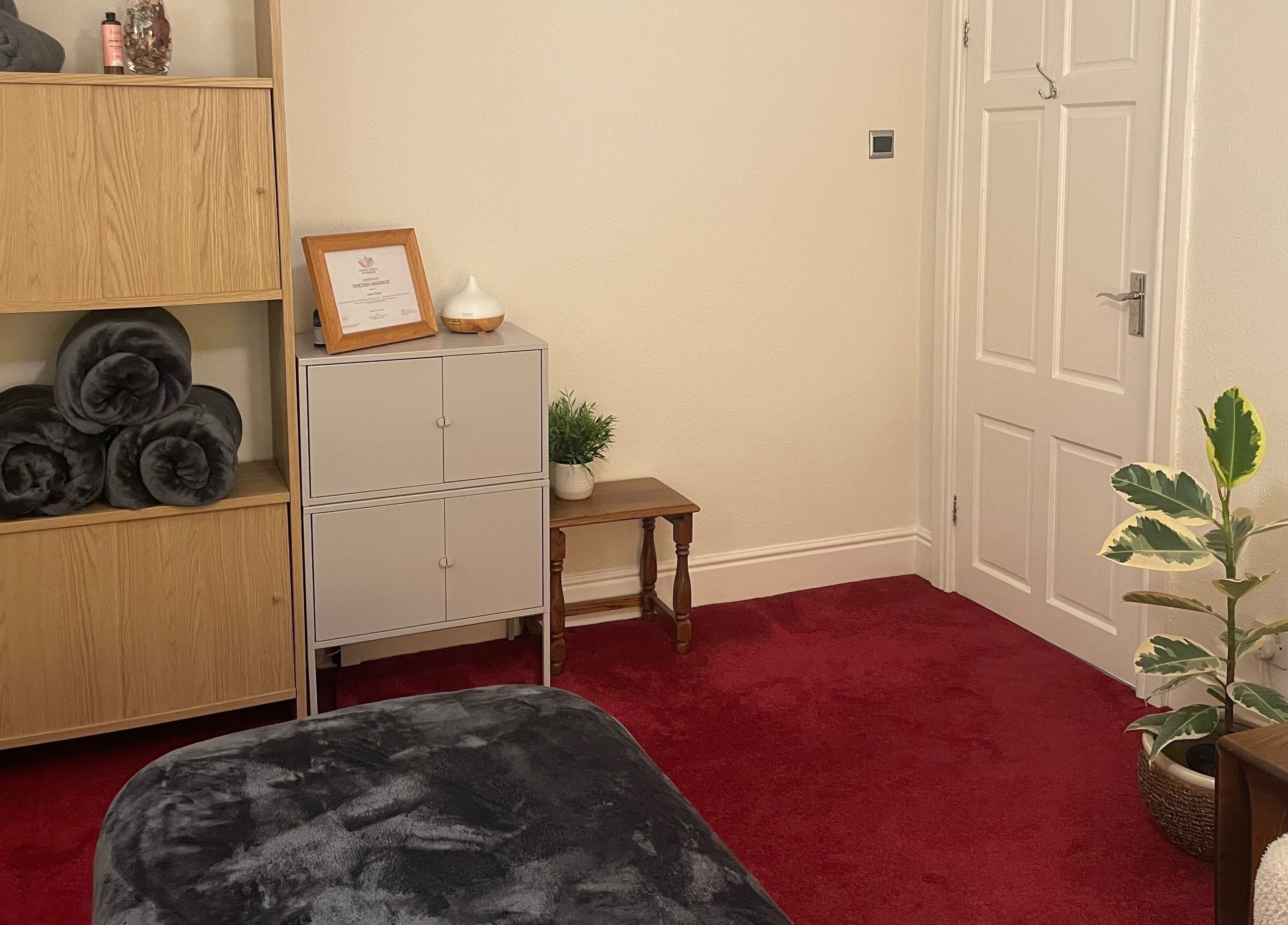 Cozy interior of Leamington Therapy, Royal Leamington Spa, England, with plush towels and calming decor.