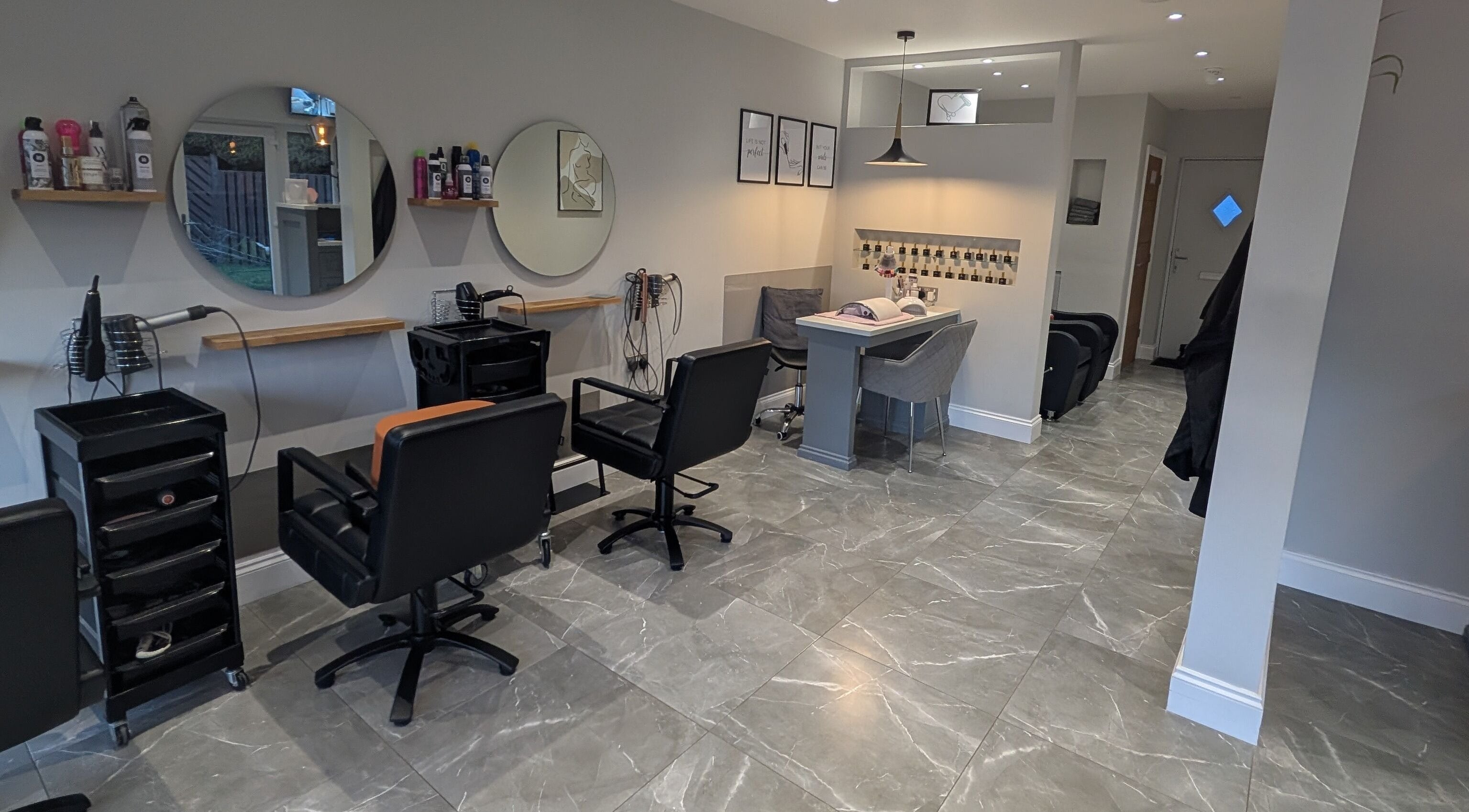 Modern salon interior at Ela V Hair & Beauty, Johnstown, Wales, GB with stylish chairs and decor.