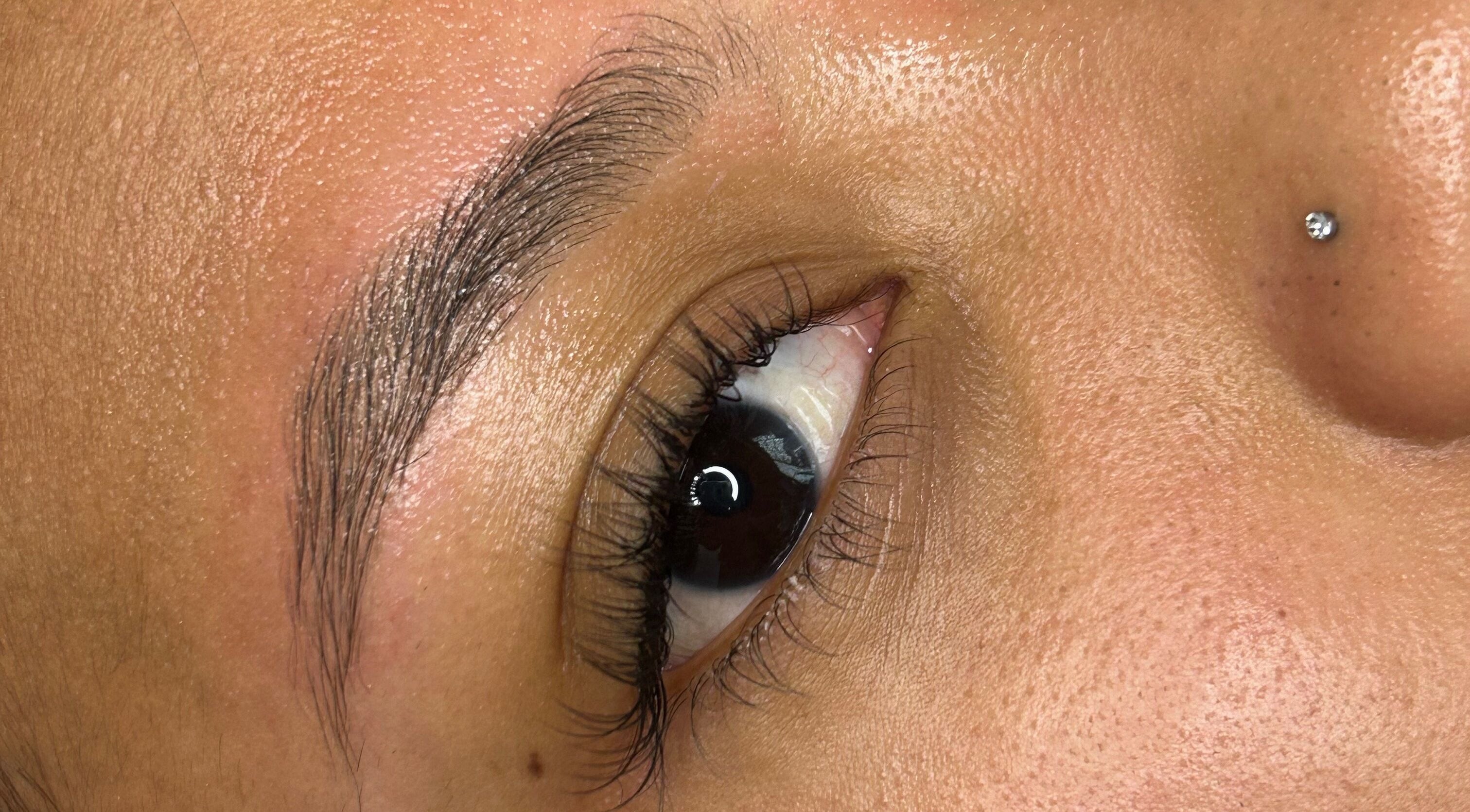 Close-up of perfectly groomed eyebrow and eye at S Lashbar, Cape Town, Western Cape, ZA.