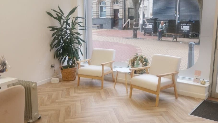 Inviting lounge area at Hippi Lash + Beauty, Sutton-in-ashfield, England, GB, with chairs and plants.