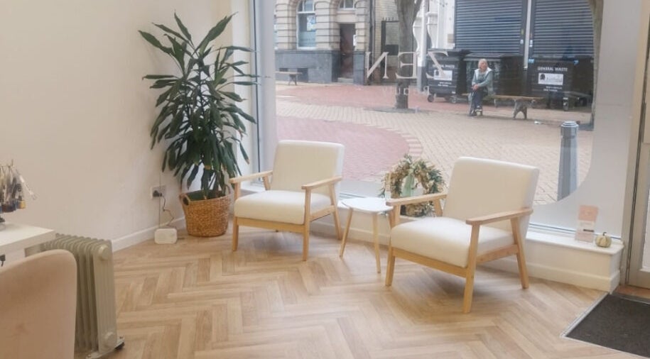 Inviting lounge area at Hippi Lash + Beauty, Sutton-in-ashfield, England, GB, with chairs and plants.