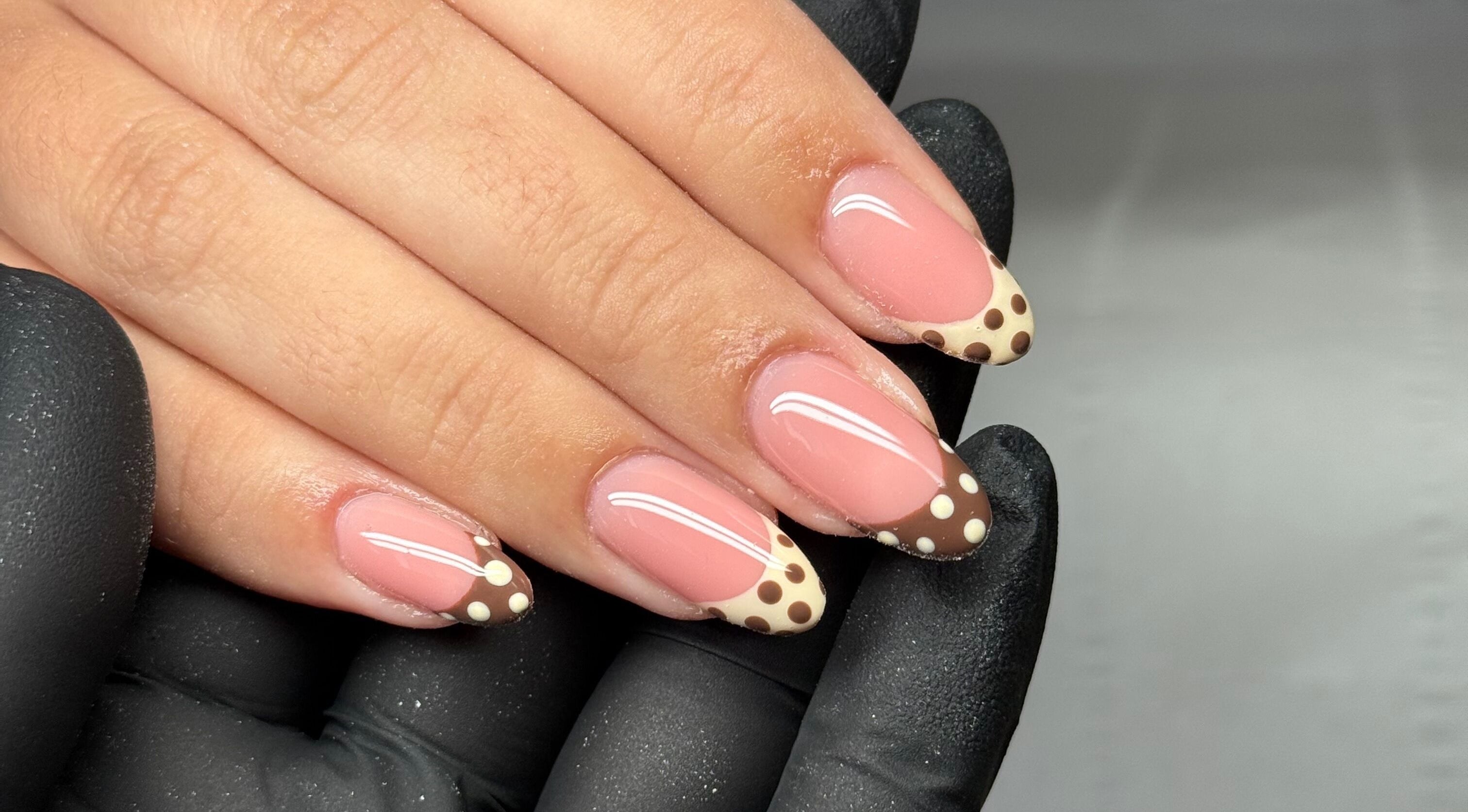 Elegant nail art with brown polka dots at Sculpt Beauty Lounge, Ewloe Green, Ewloe, Wales, GB.