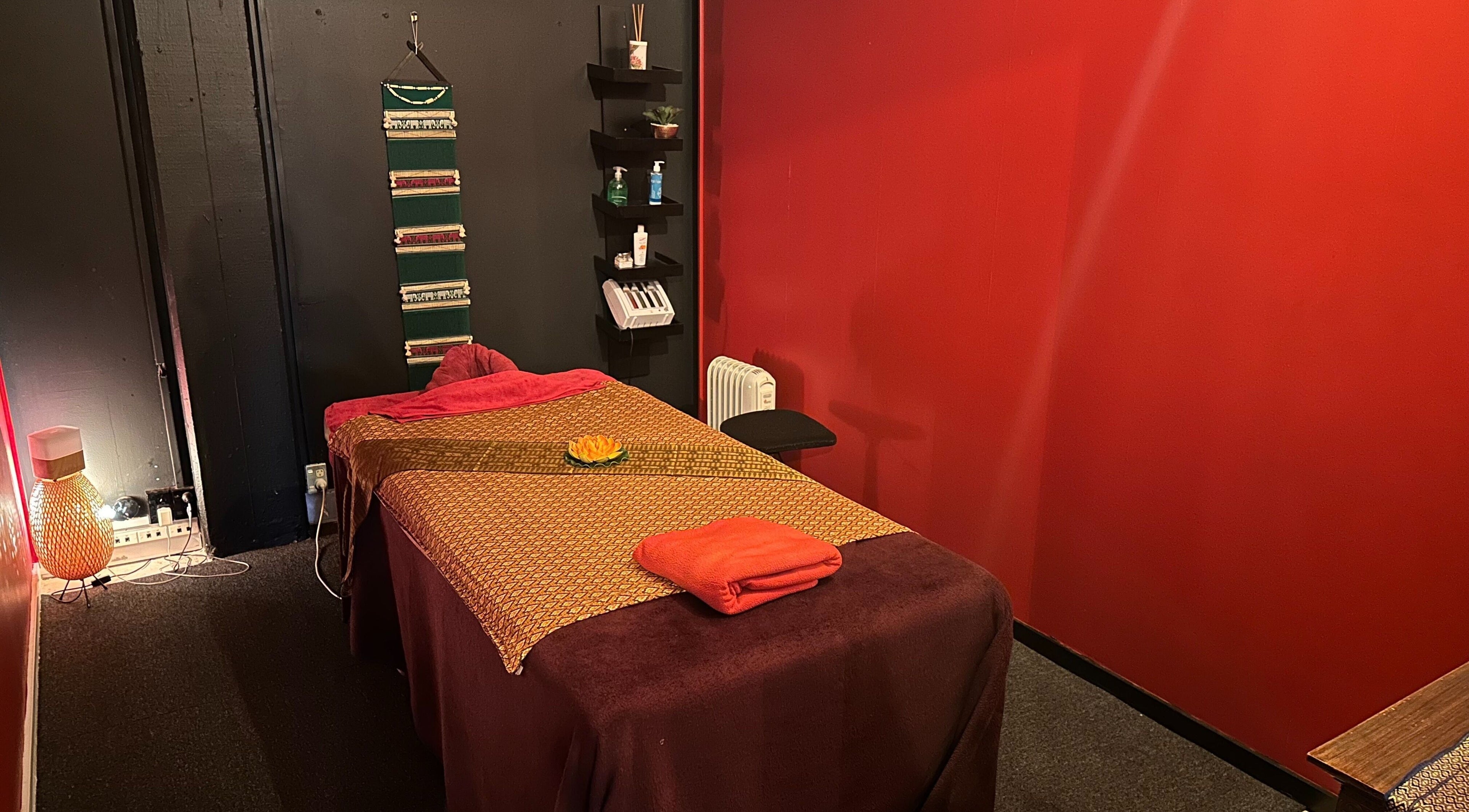 Relaxing massage room at OrientalBay Amarin Thai Massage & Spa, Wellington, Wellington, NZ with warm decor.