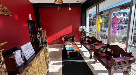 Elegant lounge area at OrientalBay Amarin Thai Massage & Spa in Wellington, Wellington, NZ with ornate wooden seating.