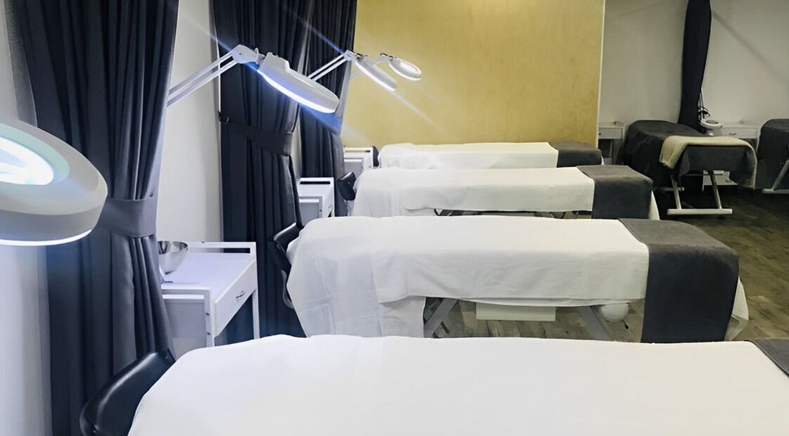 Modern treatment beds at Ccbt Student Salon in Melbourne, Victoria, AU offer a tranquil wellness experience.