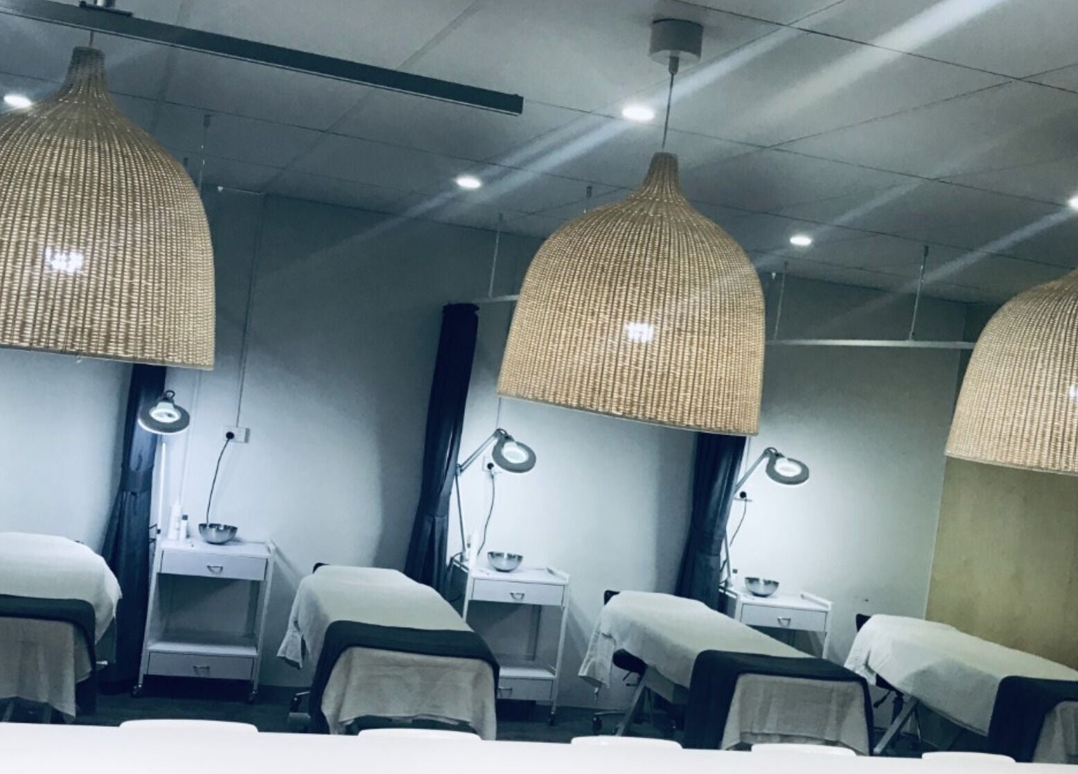 Serene treatment area at Ccbt Student Salon, Melbourne, Victoria, AU, showcasing cozy beds and ambient lighting.