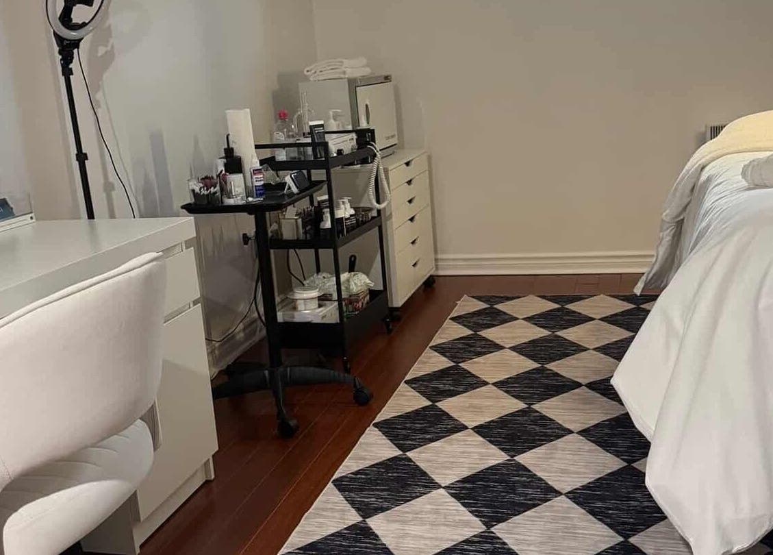 Relaxing spa room at She by Eva, Brossard, Québec, CA, featuring treatment bed and modern decor.