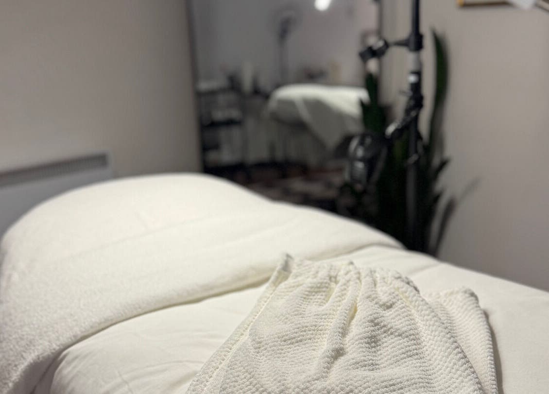 Relaxing spa treatment room at She by Eva, Brossard, Québec, CA, featuring a cozy massage table setup.