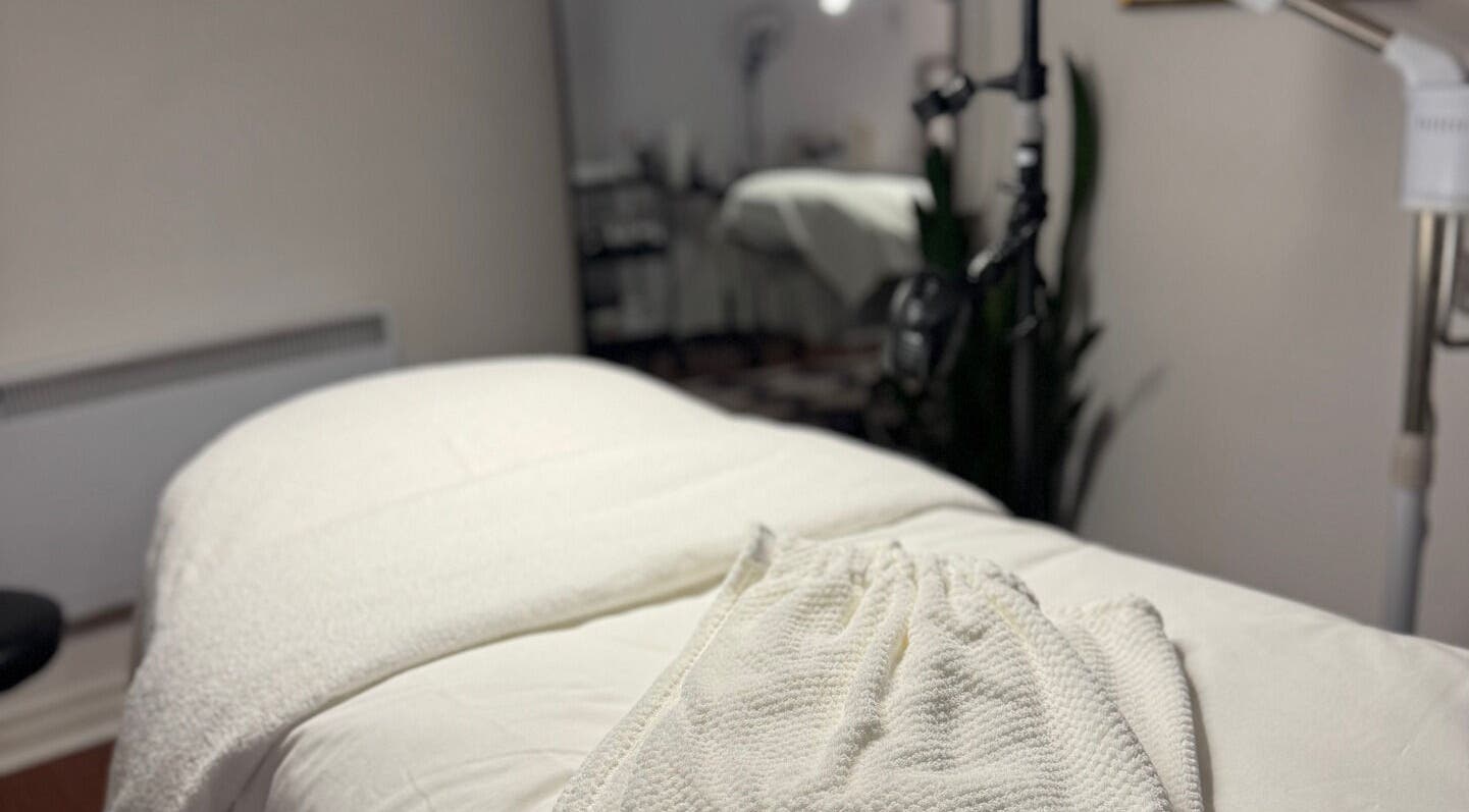 Relaxing spa treatment room at She by Eva, Brossard, Québec, CA, featuring a cozy massage table setup.