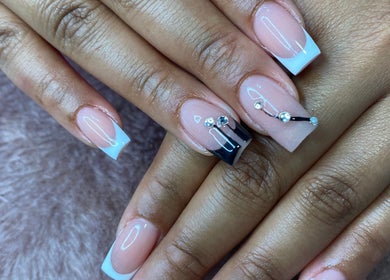 Elegant nail art at Bkt Nails, Pretoria, Gauteng, ZA featuring dazzling rhinestone accents on a nude base.