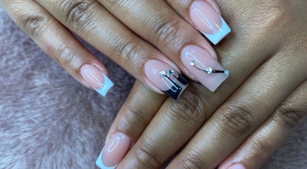Elegant nail art at Bkt Nails, Pretoria, Gauteng, ZA featuring dazzling rhinestone accents on a nude base.