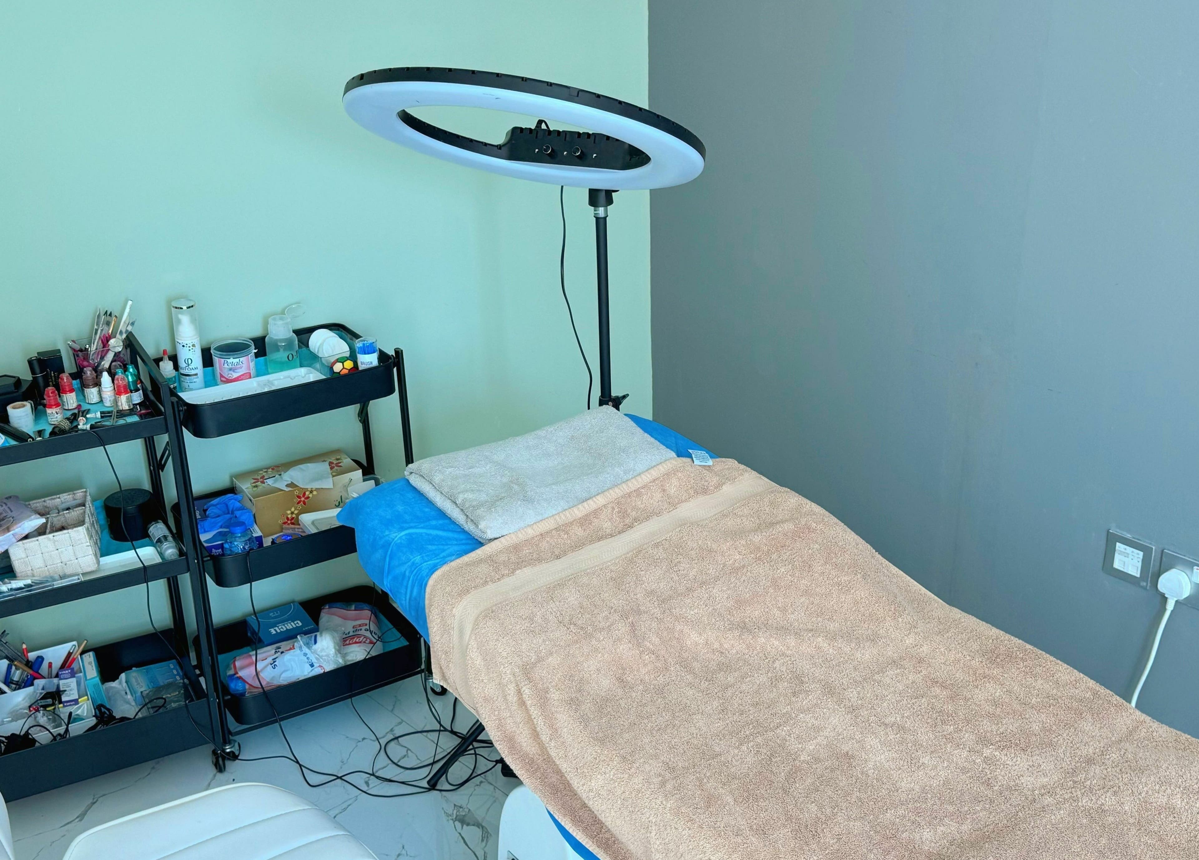 Treatment room at Sunface Medical Aesthetic Center, Dubai, Dubai, AE featuring a bed and beauty equipment.
