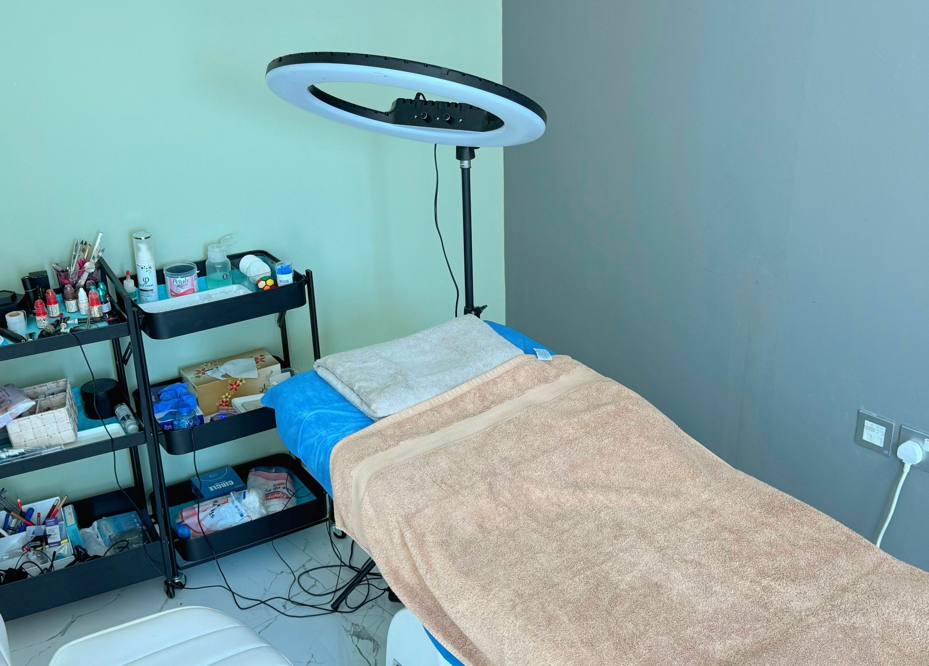 Treatment room at Sunface Medical Aesthetic Center, Dubai, Dubai, AE featuring a bed and beauty equipment.