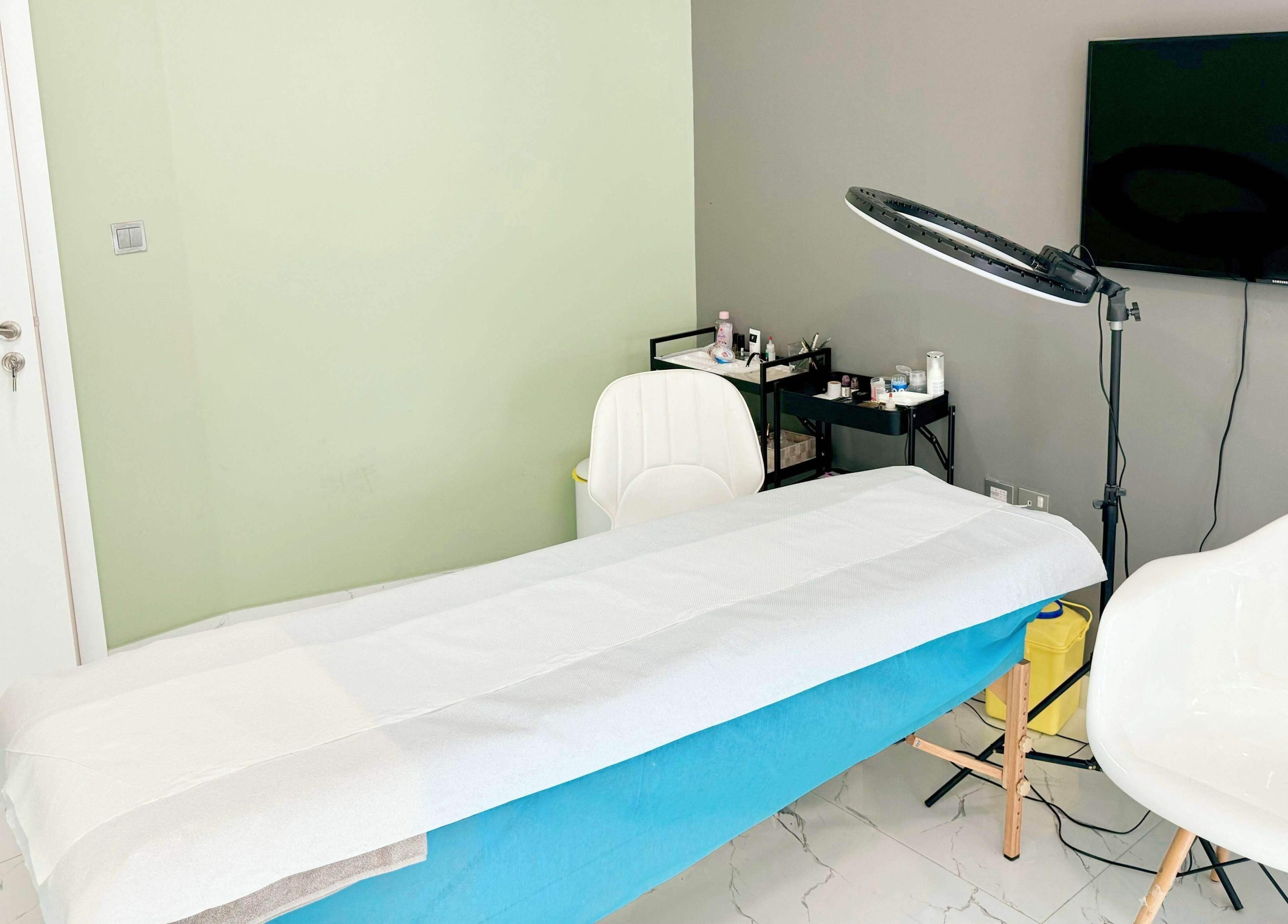 Treatment room at Sunface Medical Aesthetic Center, Dubai, Dubai, AE, featuring a comfy bed and modern setup.